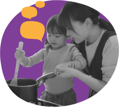 Female caregiver stirring pot with young girl. Pretend cooking or child is helping caregiver cook.